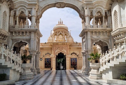 Grand ornate gateway and temple pavilion courtyard in Braj